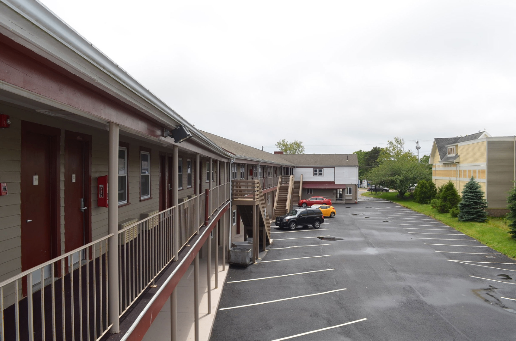 Guest room exterior corridor and parking area view at Hyannis Host Inn